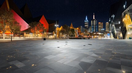 Poster - A nighttime view of a modern urban plaza with striking architecture and city skyline.