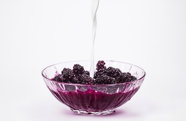 Poster - A bowl of blackberries with purple juice being poured in, creating a refreshing dessert.