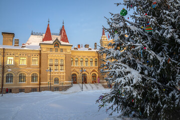 Wall Mural - View of a fragment of a Christmas tree on the background of an ancient building, Rybinsk. Yaroslavl region, Russia