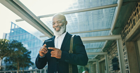 Poster - Phone, commuting and businessman in city with communication for corporate travel with email. Happy, walking and African mature CEO with online hotel checkin with cellphone for company trip in town.