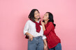 © PBXStudio - Asian lesbian woman in a red and white shirt hugging and kissing each other on a pink background