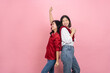 © PBXStudio - Cute Asian girl with black hair and red and white shirt dancing with long black haired woman in red shirt