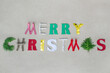 © RooM The Agency - Handmade Merry Christmas greeting with capital letters made from various materials and juniper leaves