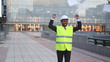 © luisrojasstock - Happy architect throwing papers celebrating success in front of modern building