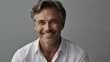 © UmmiHoney - Happy mature man smiling confidently in a studio portrait.
