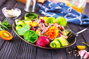 Sticker - Meat steak decorated with flowers. Sliced roasted pork steak, salad.