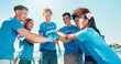 © peopleimages.com - Beach, volunteer and people with hands together for support, motivation and community service. Climate change, pollution and recycling team for ocean clean up, collaboration and social responsibility