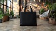 © 9BEi - Black Tote Bag Mockup in Stylish Interior.