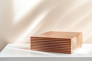 Poster - Sunlight creating shadows on a contemporary empty copper podium on a white table