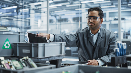 Aufkleber - Indian Male Worker Disassembling Laptops To Recycle Electronic Components For Microchip Production At an Automated Electronics Factory With Robotic Arms. Man Unscrewing Displays and Sorting Them Out