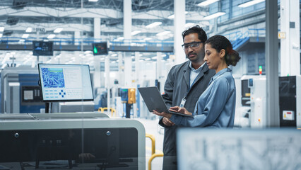 Aufkleber - Indian Male Industrial Engineer And Hispanic Female Manager Using Laptop And Talking At an Electronics Factory. Man Using Soldering Jet Printer, Explaining Process Behind Production Of Motherboards