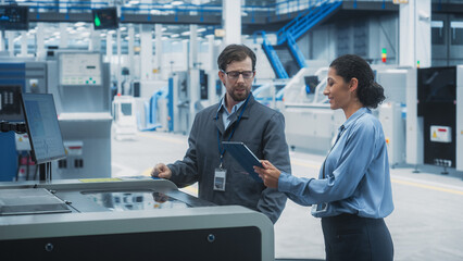 Leinwandbilder - Caucasian Male Chief Engineer And Hispanic Female Supervisor Using Tablet And Talking At Electronics Factory. Man Using Soldering Jet Printer, Explaining Process Behind Production Of Circuit Boards.