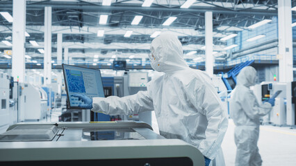 Fototapete - Printed Circuit Board Production At Electronics Factory: Technician In Sterile Suit Using Soldering Jet Printer To Make Modern Motherboards For Powerful CPU. Computer Hardware Manufacturing Facility.