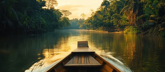 Poster - Serene long tail boat navigating a tranquil river at sunset surrounded by lush tropical vegetation