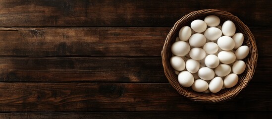 Aufkleber - Circular wooden basket filled with white eggs on dark wooden table Seasonal holiday flat lay with space for text or design elements