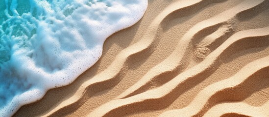Poster - Waves creating textured patterns on golden sand at the beach with gentle ocean foam and pristine shoreline for a serene landscape backdrop