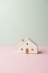 Poster - A small model house is selectively focused on a soft pastel colored background in this visually appealing image._00004_