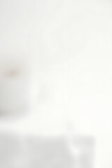 Poster - A simple white wooden tabletop sits atop a soft, blurred white background with subtle depth of field effects surrounding it._00002_