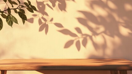 Poster - empty tabletop with soft shadows from leaves on a wall creating a serene backdrop ideal for showcasi