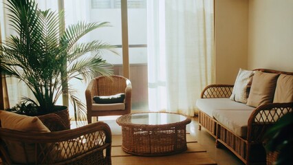 Poster - A peaceful sunroom filled with an assortment of natural textures featuring rattan furniture a large indoor palm and drapes that gently diffuse sunlight. A woven coffee table sits