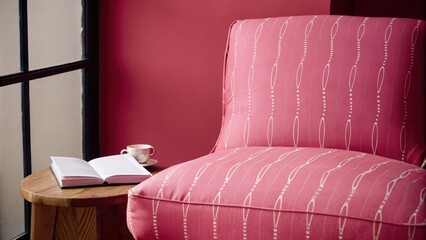 Aufkleber - A cozy reading nook showcases a chair upholstered in a soft fabric adorned with delicate linear patterns paired with a wooden side table and a large window allowing natural light