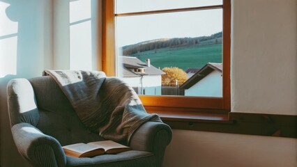 Aufkleber - A cozy reading nook with a plush armchair and an inviting throw positioned by a window where sunlight spills in offering a perfect vantage point to enjoy the serene village