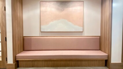 Poster - An elegant entryway boasting a muted pink bench and light wood accents. A large canvas depicting soft abstract forms in pastel shades hangs above creating a warm and welcoming