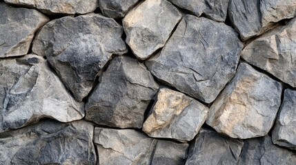 Leinwandbilder - Textured close-up of natural stone wall featuring various sizes of rough, irregularly shaped rocks showcasing earthy tones and rugged beauty