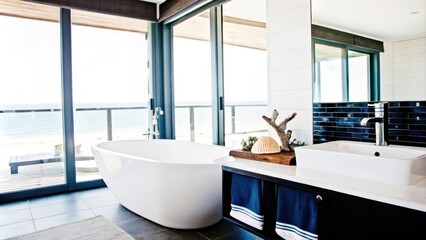 Aufkleber - An elegant bathroom with freestanding white tub and polished fixtures is adorned with oceaninspired decor offering large windows that bring in natural light and frame a stunning