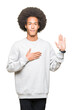 © Krakenimages.com - Young african american man with afro hair wearing sporty sweatshirt Swearing with hand on chest and open palm, making a loyalty promise oath