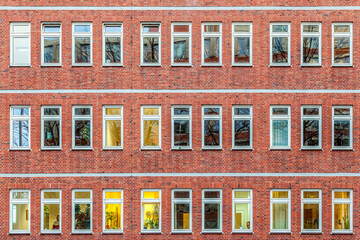 Wall Mural - facade of office building in the evening with illuminated windows