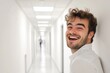 © Ева Поликарпова - A person smiling while standing in a hallway