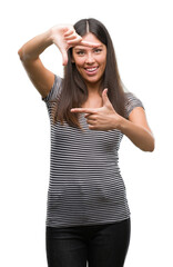 Wall Mural - Young beautiful hispanic woman smiling making frame with hands and fingers with happy face. Creativity and photography concept.