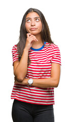 Wall Mural - Young beautiful arab woman over isolated background with hand on chin thinking about question, pensive expression. Smiling with thoughtful face. Doubt concept.