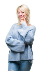 Wall Mural - Young beautiful blonde woman wearing winter sweater over isolated background looking confident at the camera with smile with crossed arms and hand raised on chin. Thinking positive.