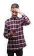 © Krakenimages.com - Young hipster adult man holding smartphone stressed with hand on head, shocked with shame and surprise face, angry and frustrated. Fear and upset for mistake.