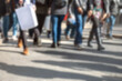 © Lawrey - Pedestrians – feet of people walking on busy city street sidewalk. Abstract urban scene depicting crowd of multicultural shoppers on metropolitan road carrying shopping bags. Intentionally blurred.