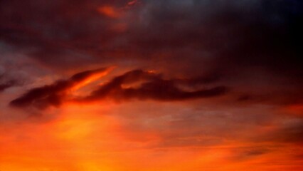Poster - Abstract dark red and yellow sky background with burning sky effect, and rays of sunlight during sunset. Topics: hot colors, cloudy background, weather, meteorology, climate, air space, atmosphere