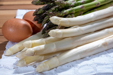 Wall Mural - Spring season, new harvest of Dutch, German white asparagus, bunch of raw white and green asparagus and free range farmers chicken eggs