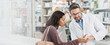 © peopleimages.com - Pharmacist, medication and consulting with customer on banner for instruction, side effects or symptoms at pharmacy. Doctor, medical worker and talking with patient for pharmaceuticals at dispensary