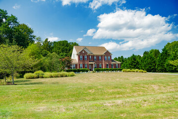 Large single family farmhouse style country home with large lawn area