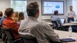 © Samraoy - Business professionals gathered at seminar listening to a presentation in a conference room