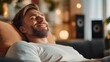 © LifeMedia - A delighted man relaxes with his eyes closed, soaking in the warm ambiance of a comfortable room, symbolizing tranquility and happiness.