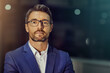 © peopleimages.com - Office, serious and portrait of business man at night with confidence, pride and working late. Professional, mockup space and person for finance consultant, corporate manager and career ambition