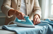 © Родион Бондаренко - elderly woman pensioner ironing clothes on ironing board