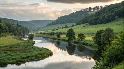 Wall Mural - calm river flowing through lush green valley at sunset, reflecting clouds and trees on its surface, 