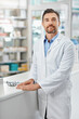 © peopleimages.com - Healthcare, portrait and mature man in pharmacy with confidence, pharmaceutical medicine or care in store. Health, service and face of professional pharmacist at dispensary counter for medical advice