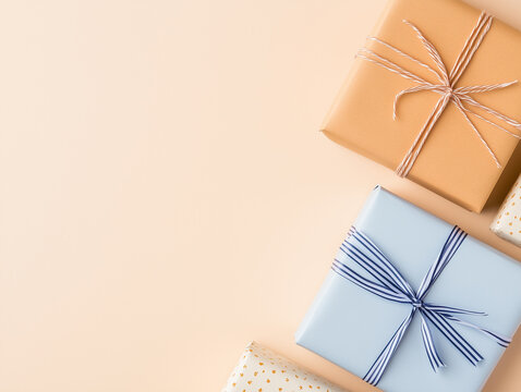 Gift boxes wrapped in paper with ribbon and bow on pink