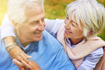 Wall Mural - Sunshine, hug and senior couple in park, love and bonding together with lens flare, happiness and romance. Retirement, outdoor and mature man with old woman, embrace and cheerful with smile or break