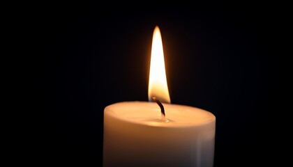 Canvas Print - burning candle on black background